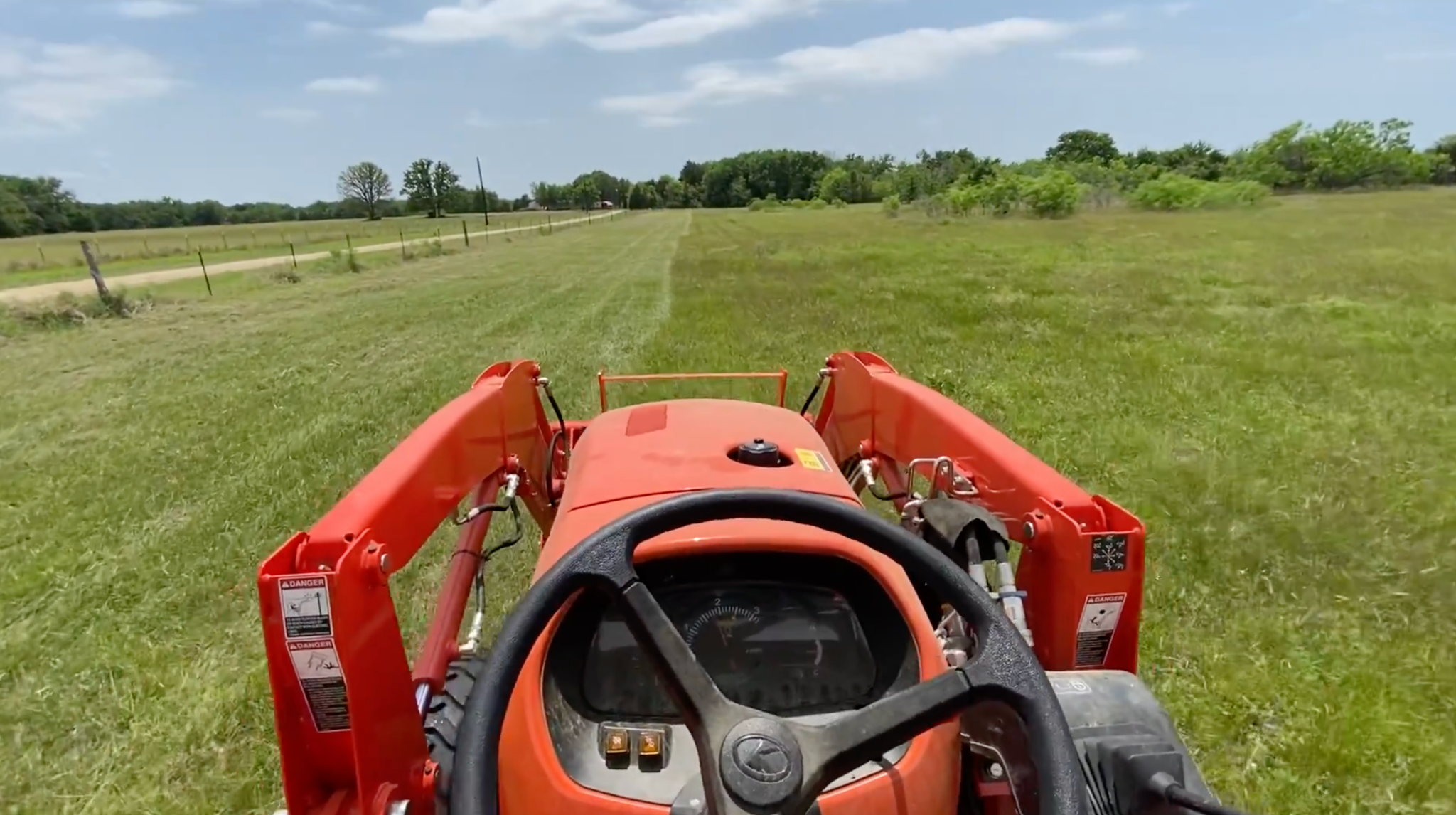 Tractor mowing acreage in the Texas Hill Country
