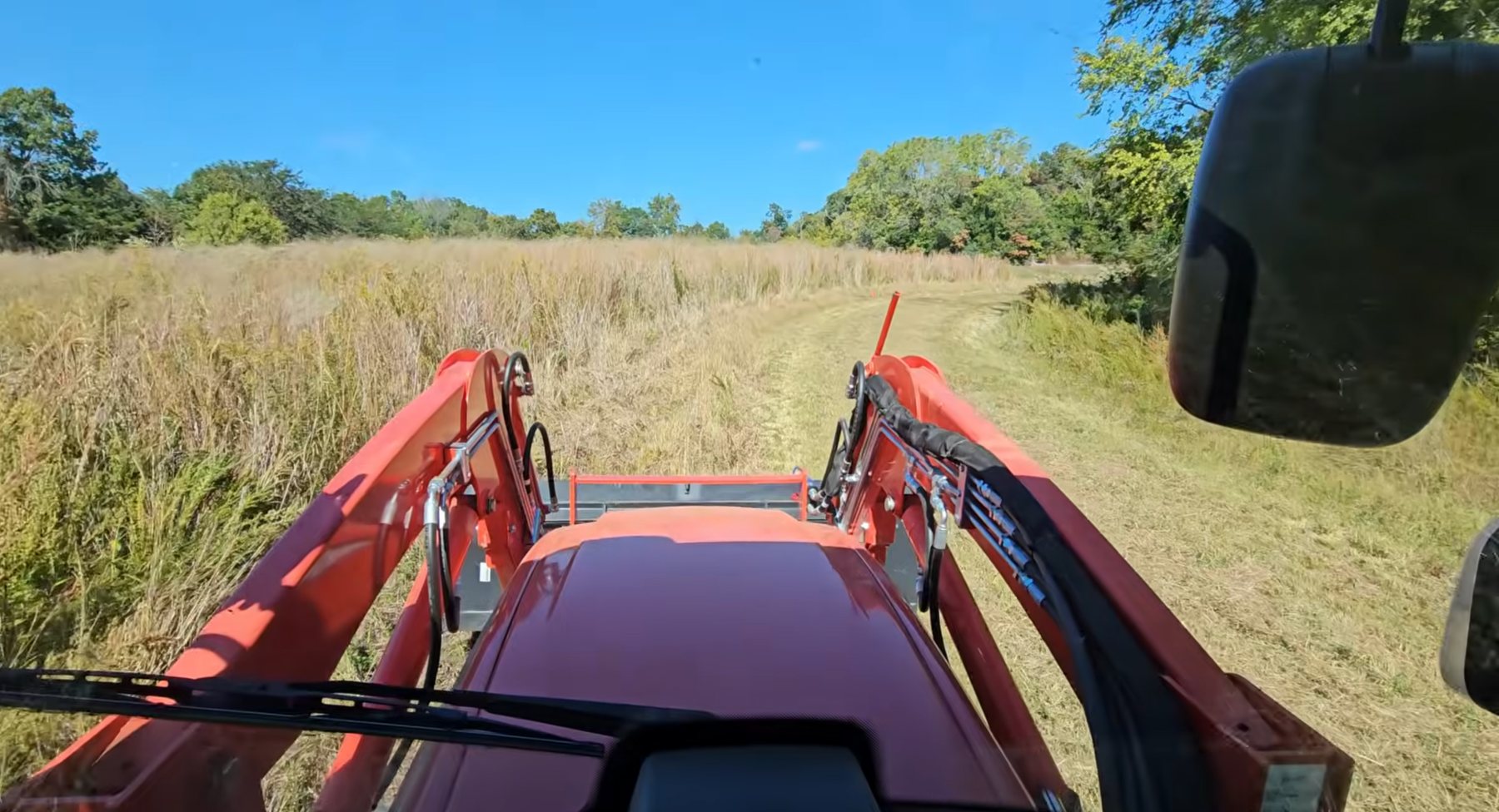 Tractor mowing acreage