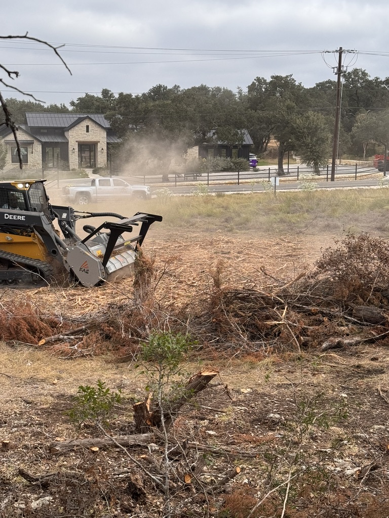 Forestry mulching equipment working through piled cedar and brush